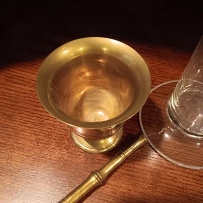 NEEDLEPOINT PHARMACY PICTURE, TALL GLASS BEEKER AND BRASS PESTLE & MORTAR