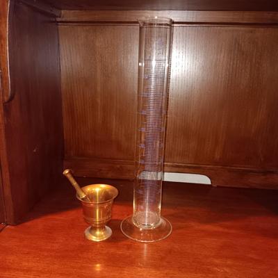 NEEDLEPOINT PHARMACY PICTURE, TALL GLASS BEEKER AND BRASS PESTLE & MORTAR