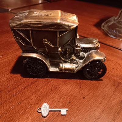 TALL GLASS OIL LAMP AND A METAL CAR BANK WITH THE KEY