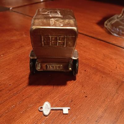 TALL GLASS OIL LAMP AND A METAL CAR BANK WITH THE KEY