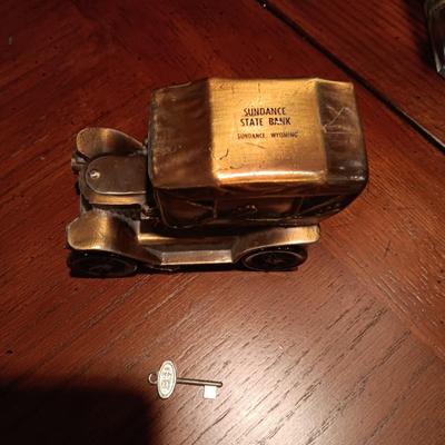 TALL GLASS OIL LAMP AND A METAL CAR BANK WITH THE KEY