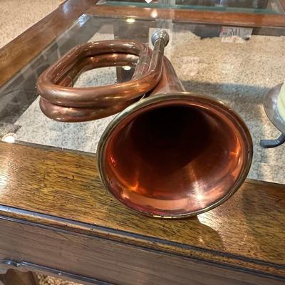 VINTAGE COPPER AND BRASS BUGLE AND A COILED CANDLE BY THE HOUR