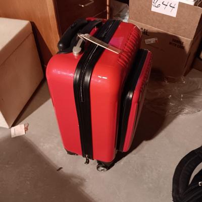 LIKE NEW RED CARRY ON WITH 4 WHEELS AND DUFFLE BAG ON 2 WHEELS