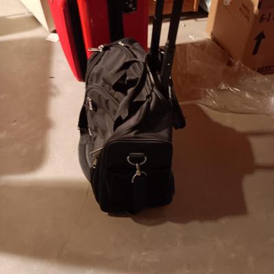 LIKE NEW RED CARRY ON WITH 4 WHEELS AND DUFFLE BAG ON 2 WHEELS