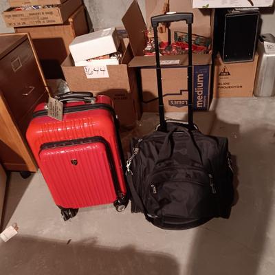 LIKE NEW RED CARRY ON WITH 4 WHEELS AND DUFFLE BAG ON 2 WHEELS