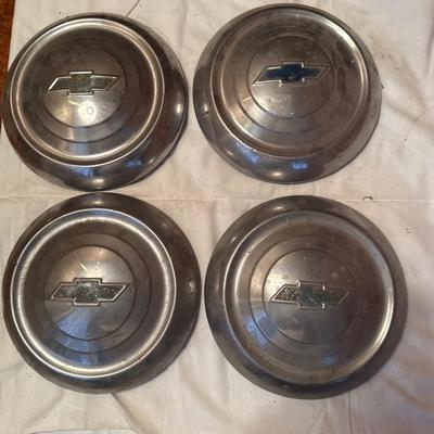 The object pictured is a Chevrolet "Dog Dish" hubcap, likely from the model years 1951-1953.