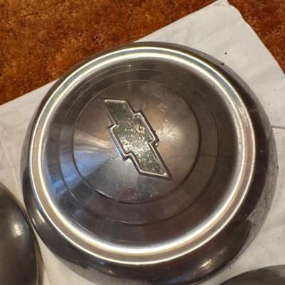 The object pictured is a Chevrolet "Dog Dish" hubcap, likely from the model years 1951-1953.