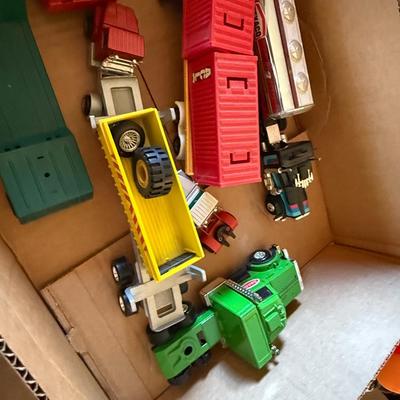 2 boxes of vintage trucks/tractors/toys
