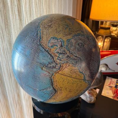 Vintage large spinning globe on black plexiglass stand