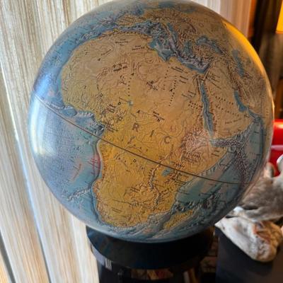 Vintage large spinning globe on black plexiglass stand