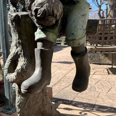 Bronze life sized boy sitting on tree stump with puppy about 4’ tall