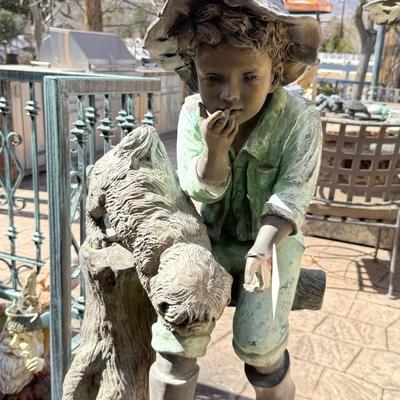 Bronze life sized boy sitting on tree stump with puppy about 4’ tall