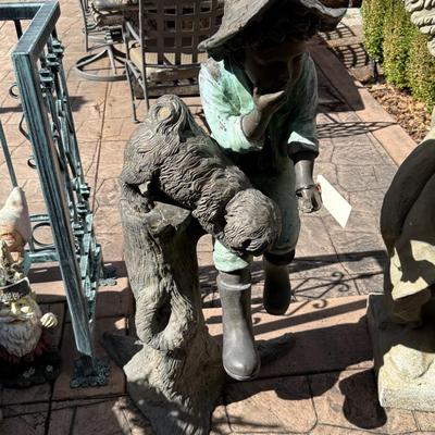 Bronze life sized boy sitting on tree stump with puppy about 4’ tall
