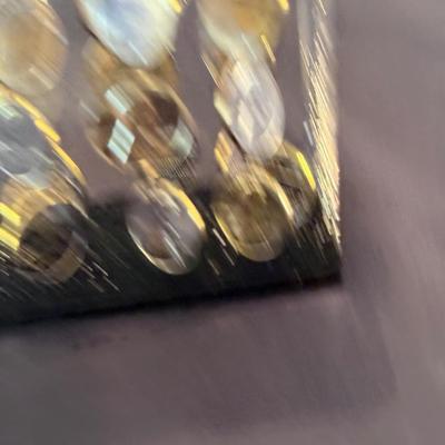 Acrylic cube with shiny pennies floating inside