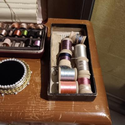 ANTIQUE CHAIR ON CASTERS AND A SMALL 4 DRAWER CHEST PACKED WITH SEWING NOTIONS AND CRAFT SUPPLIES