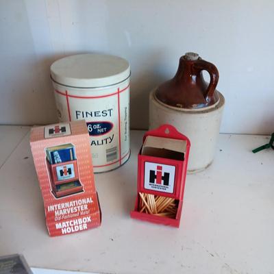 CLAY JUG, INTERNATIONAL HARVESTER MATCH HOLDER AND AN OLD TIN