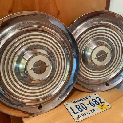 2 vintage Oldsmobile hubcaps and small license plate