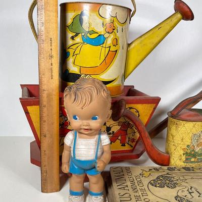 LOT 75: Vintage Children's Toys - Watering Cans, Doll (The Sun Rubber Co / Ruth E Newton), Wooden Cart, Books and More