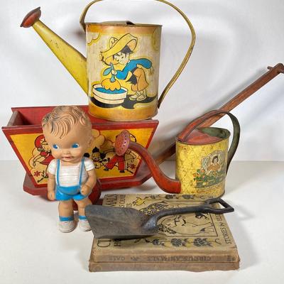 LOT 75: Vintage Children's Toys - Watering Cans, Doll (The Sun Rubber Co / Ruth E Newton), Wooden Cart, Books and More