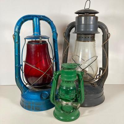 LOT 80: Vintage Oil Lanterns - 2 Dietz (Blue / Gray) and 1 Green Winged Wheel