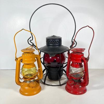LOT 81: Vintage Black and Red Dressel Oil Lantern and Two Winged Wheel (Yellow and Red)