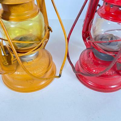 LOT 81: Vintage Black and Red Dressel Oil Lantern and Two Winged Wheel (Yellow and Red)