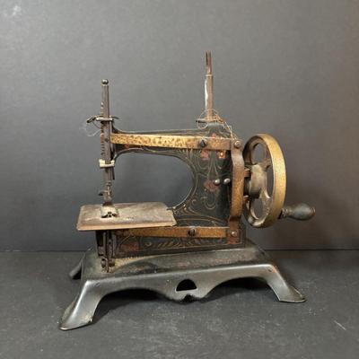 LOT 88: Antique Toy Sewing Machine Made in Germany, Sewing Notions & Button Shelf Sitter Doll