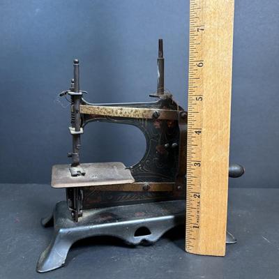 LOT 88: Antique Toy Sewing Machine Made in Germany, Sewing Notions & Button Shelf Sitter Doll
