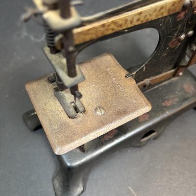 LOT 88: Antique Toy Sewing Machine Made in Germany, Sewing Notions & Button Shelf Sitter Doll