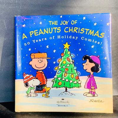 LOT 134: Vintage Peanuts Snoopy Astronaut from 1969 and 50th Anniversary Peanut Holiday Book and Snow Globe