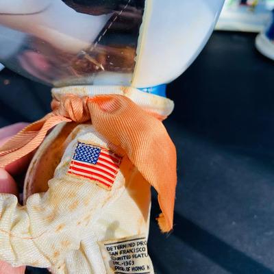 LOT 134: Vintage Peanuts Snoopy Astronaut from 1969 and 50th Anniversary Peanut Holiday Book and Snow Globe