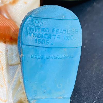 LOT 134: Vintage Peanuts Snoopy Astronaut from 1969 and 50th Anniversary Peanut Holiday Book and Snow Globe