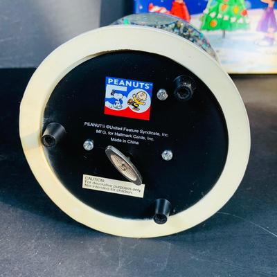 LOT 134: Vintage Peanuts Snoopy Astronaut from 1969 and 50th Anniversary Peanut Holiday Book and Snow Globe