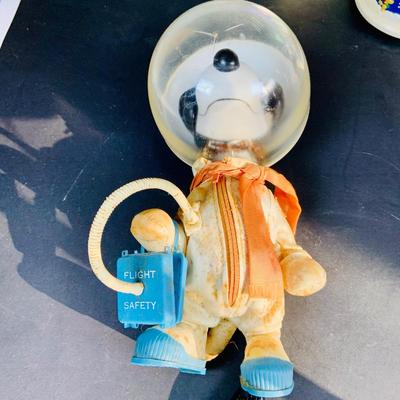 LOT 134: Vintage Peanuts Snoopy Astronaut from 1969 and 50th Anniversary Peanut Holiday Book and Snow Globe