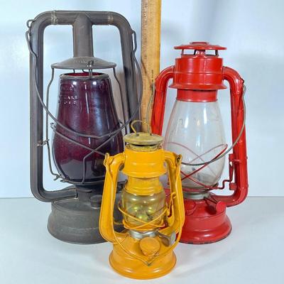 LOT 138: Three Oil Lanterns - Dietz (Gray) and Winged Wheel Brand (Red and Yellow)