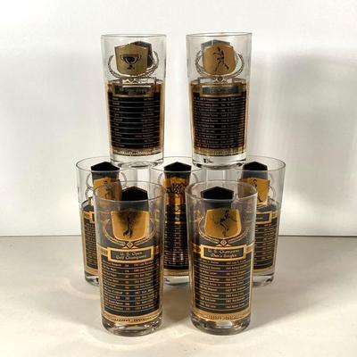 LOT 144: Seven MCM Sports Black and Gold Drinking Glasses / Barware
