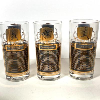 LOT 144: Seven MCM Sports Black and Gold Drinking Glasses / Barware