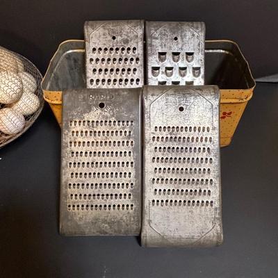 LOT 203: Antique Cast Iron Dover Egg Beater, Vintage Bread Tin, Graters, Utensils, Blown-out Eggs in Wire Basket