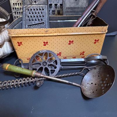 LOT 203: Antique Cast Iron Dover Egg Beater, Vintage Bread Tin, Graters, Utensils, Blown-out Eggs in Wire Basket