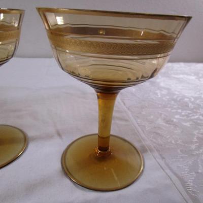 Vintage gold-rimmed champagne glasses