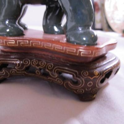 Elephant with banana figurine on stand