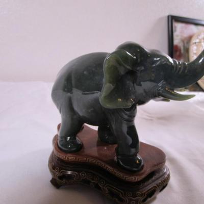 Elephant with banana figurine on stand