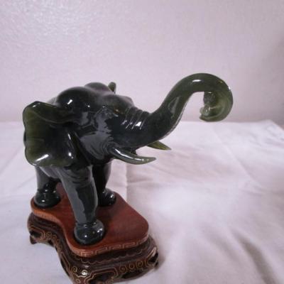 Elephant with banana figurine on stand