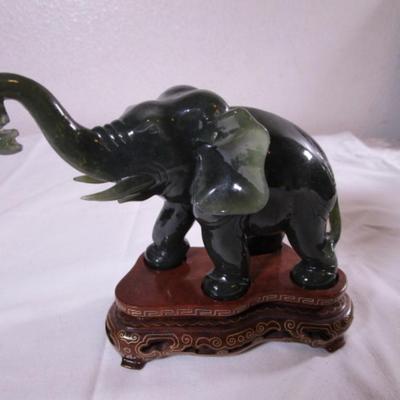Elephant with banana figurine on stand