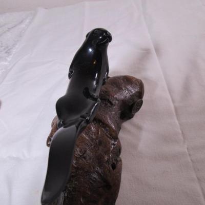 Vintage John Perry signed black otter figurine on a beryl wood stand