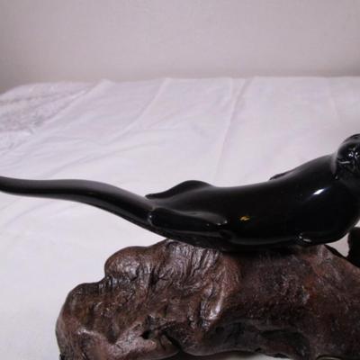 Vintage John Perry signed black otter figurine on a beryl wood stand