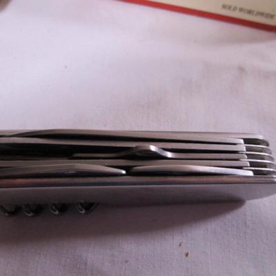 Real Leatherman with hard leather case; Geico multi-tool knife by Camillus