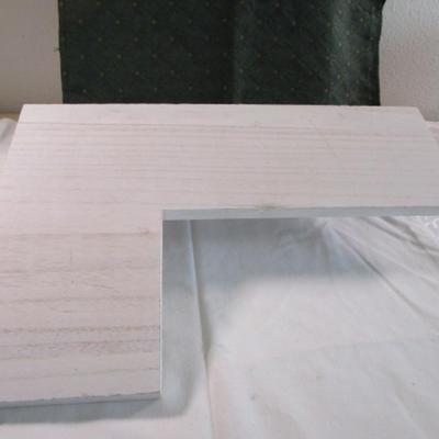 White wood corner shelf with metal brackets