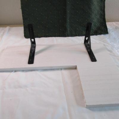 White wood corner shelf with metal brackets