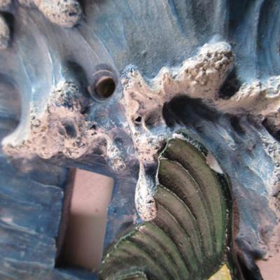 Light switch covers, one is mirrored, one has a fish